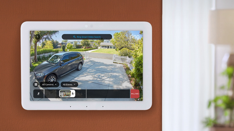 Smart home hub displaying live surveillance view of front driveway with car