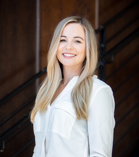 A headshot of Courtney Jones, CEO and founder of the ClearTheList Foundation and #ClearTheList, smiling against a black background.