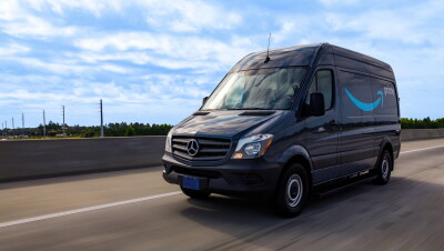 A cargo van decorated with the Amazon smile logo and the word "Prime."