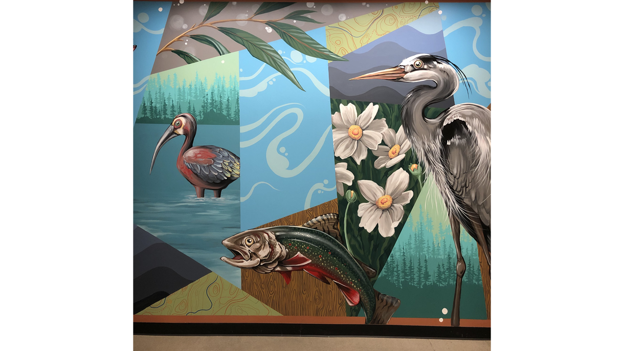 An image of a painted mural showing two large birds and a fish at Amazon Denver.