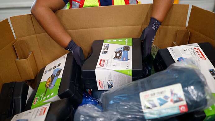 A volunteer helps pack donated supplies at an Amazon fulfillment center to support Hurricane Ian relief