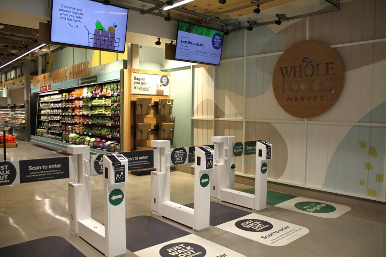 An image of the entrance of a Whole Foods Market store with Just Walk Out technology installed at the entrance. 