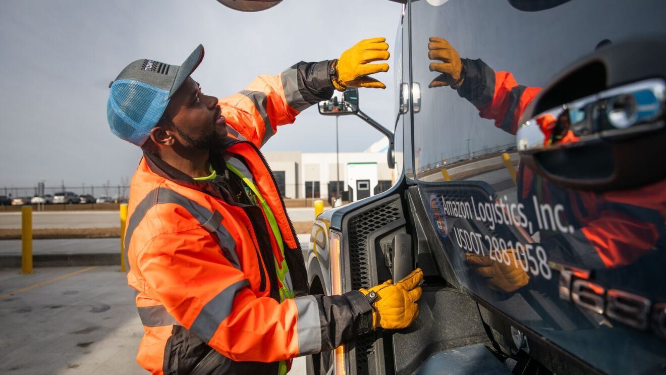 portraits and environmental photos of abel tuyisenge, a transportation operations management associate at amazon, as he drives and inspects trucks