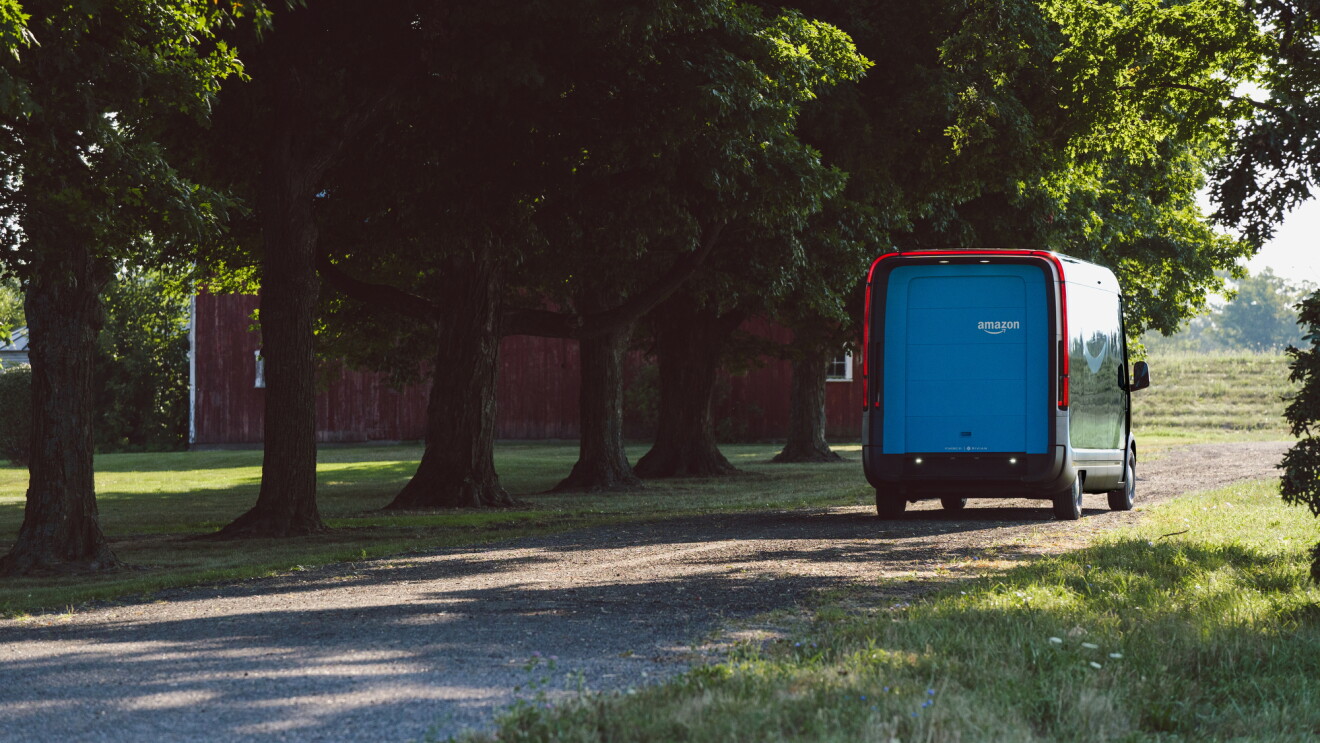 Amazon electric delivery vehicle driving away on a country road.