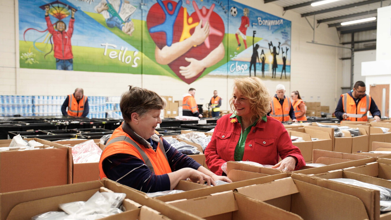 Workers pack boxes at Amazon's Multibank hub in Swansea