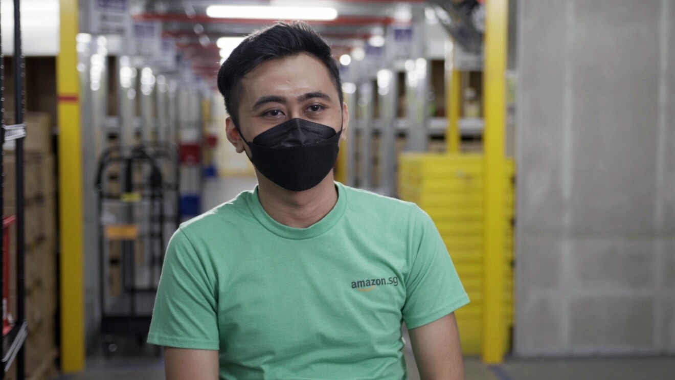 Amazon associate Farid Bin Rojion talks about his journey with Amazon against the backdrop of Amazon's fulfillment center in Singapore