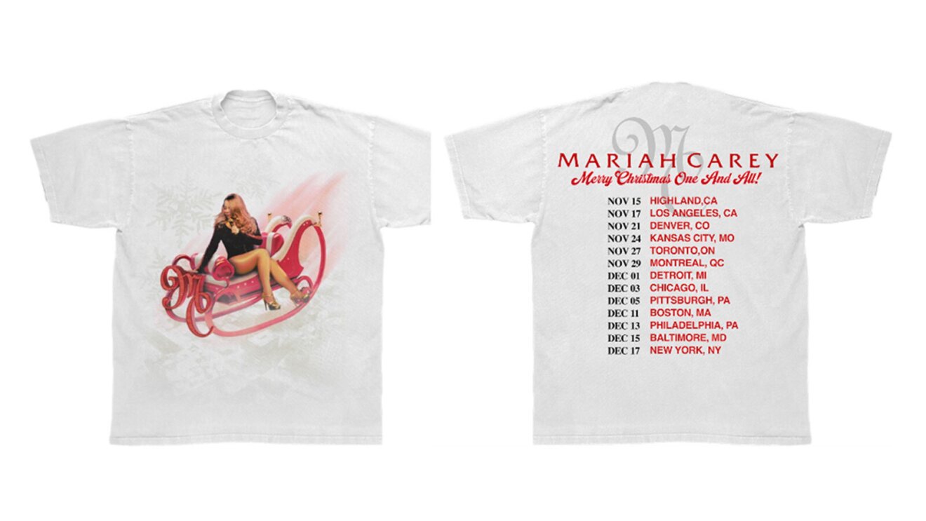 A white shirt with an image of Mariah Carey riding a red sleigh on the front. On the back is a list of all of the stops on her holiday tour, and the text above reads "Mariah Carey"