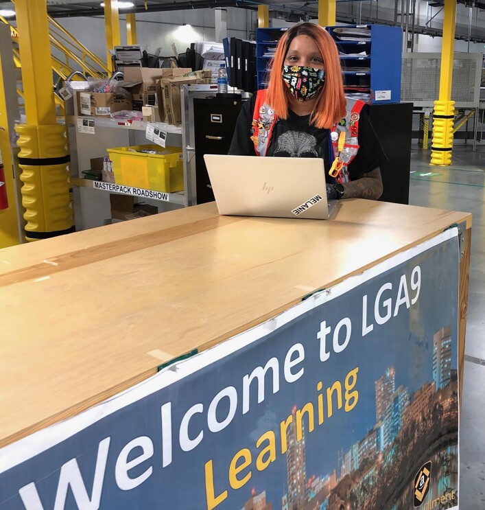 Woman Amazon associate wearing a mask while working