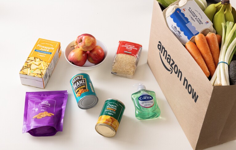 A selection of groceries, including soap, some cans of beans, apples and dried apricots.