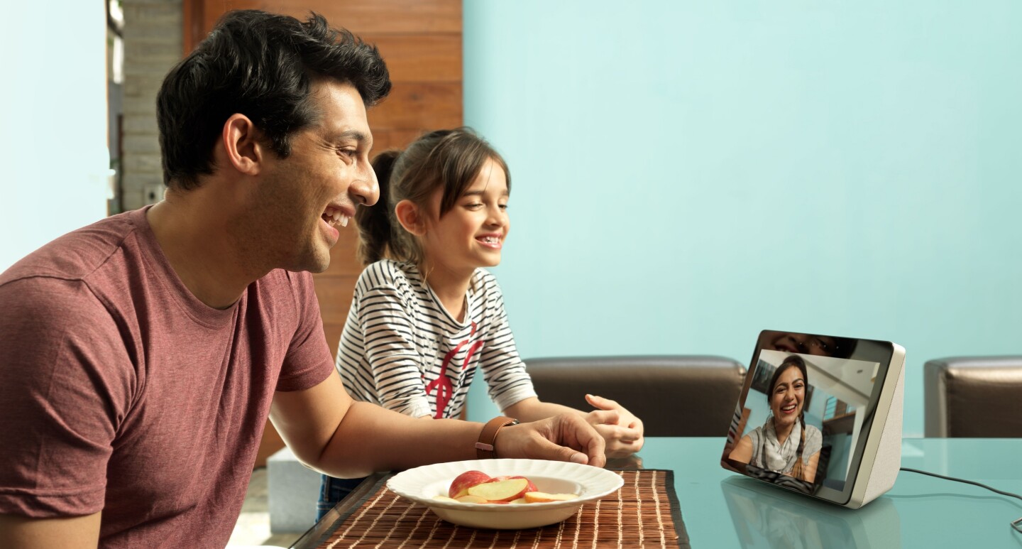 A man and a little girl (maybe father and daughter), speak to a lady (maybe the girl's mother), on an Echo show device