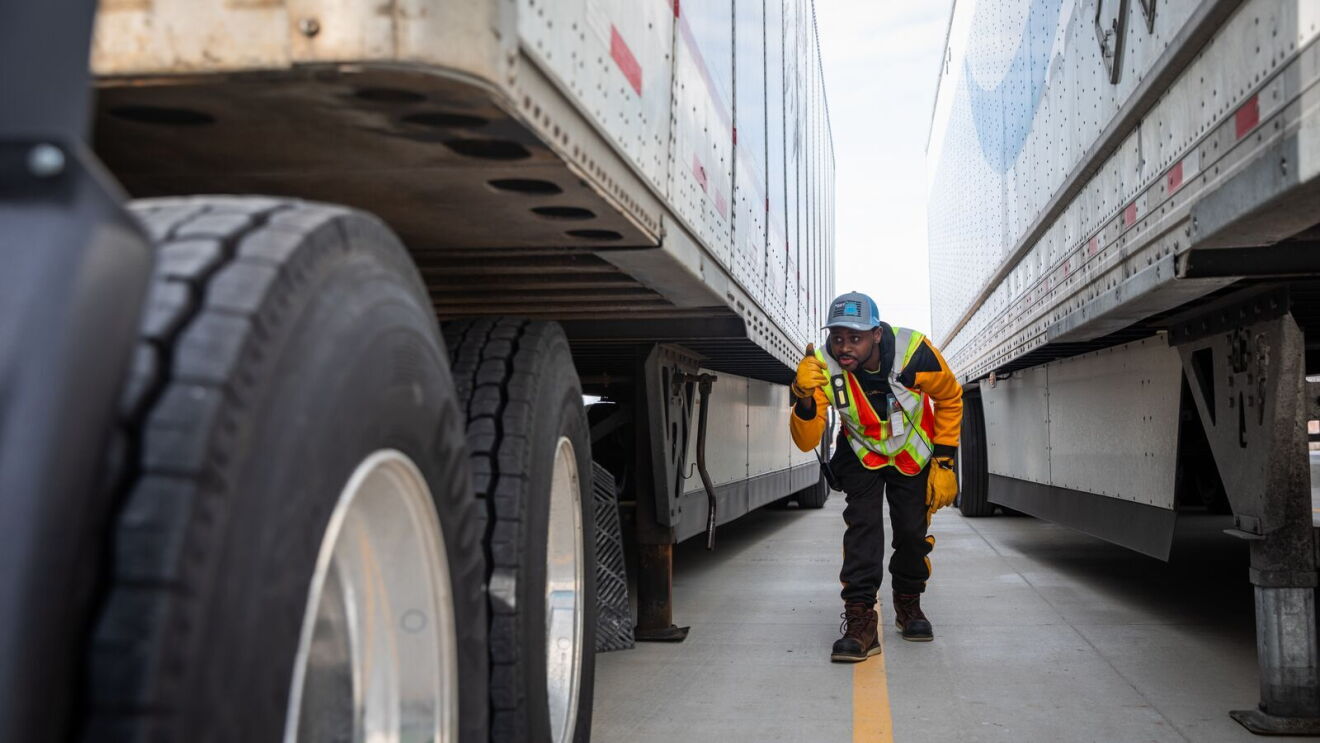 portraits and environmental photos of abel tuyisenge, a transportation operations management associate at amazon, as he drives and inspects trucks