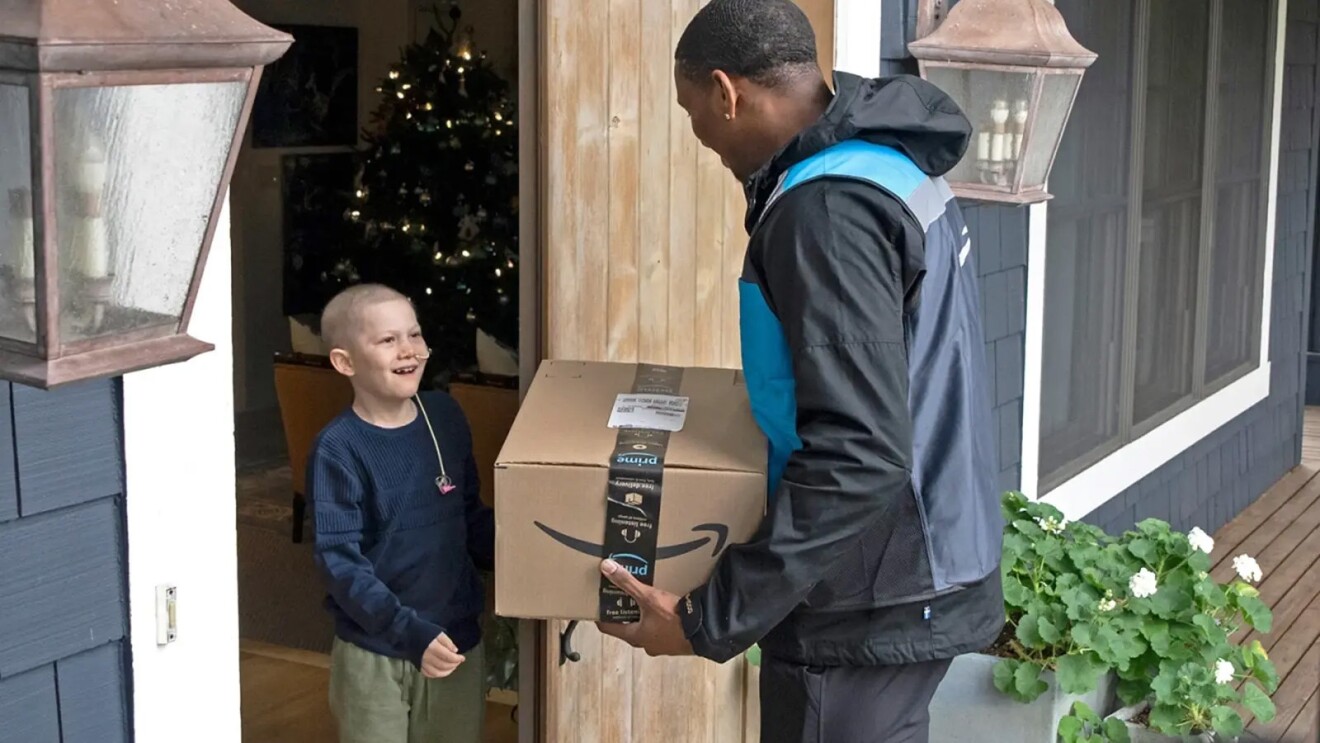 A photo of Quarterback Michael Penix, Jr. delivering an Amazon package to a child in Seattle, Washington.