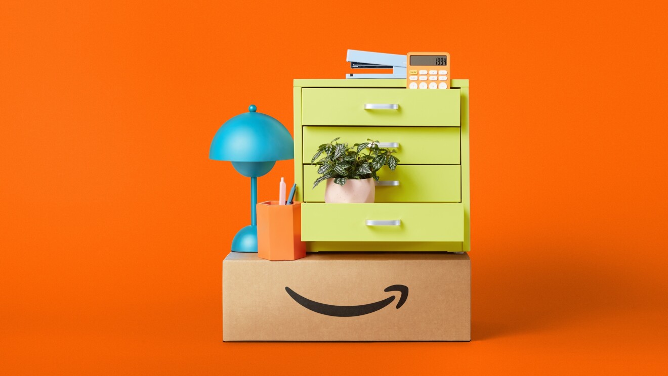 Amazon products stacked ontop of a delivery box, including a lamp and a filing cabinet