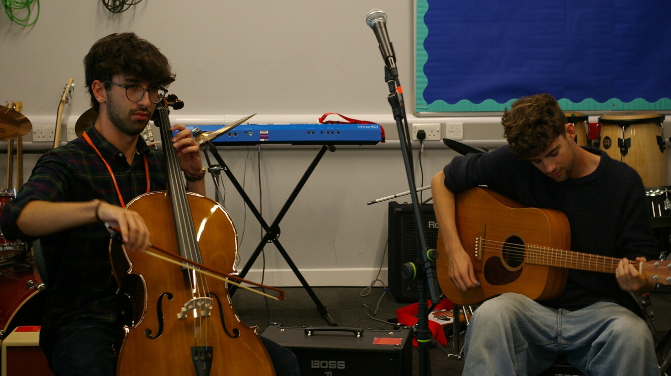 Two students from the London Academy of Excellence Tottenham use donated musical equipment.