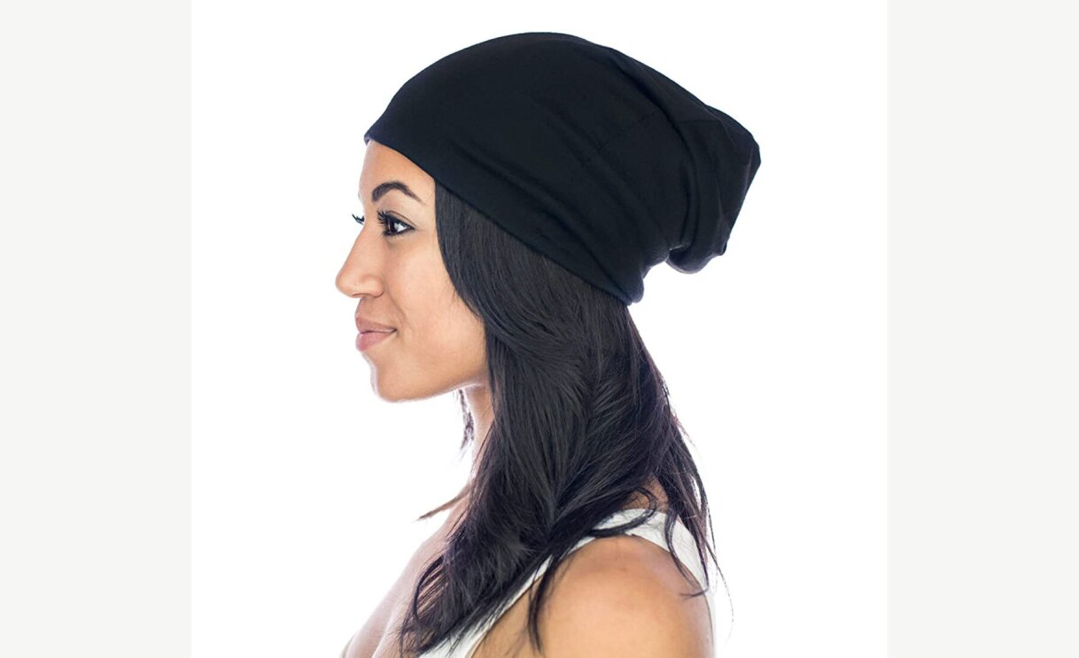 Woman wearing Grace Eleyae satin lined cap and showing her profile.