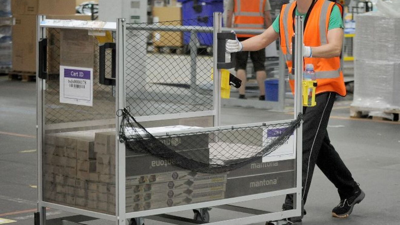 Amazon FC employee pushing a cart at a Polish fulfillment center