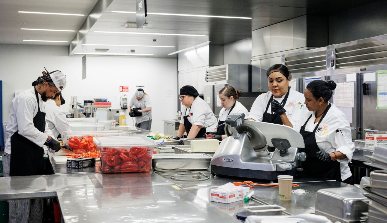 FareStart team members prepare meals together in the kitchen as part of the organization's culinary training program in Seattle.