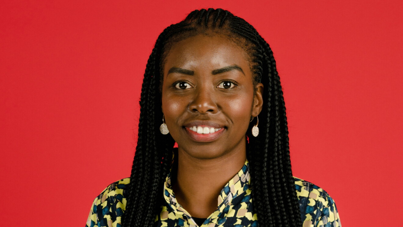 Headshot of Ramat Tejani in front of a bright red background.
