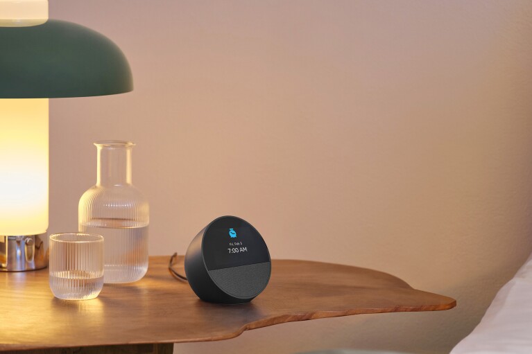 Echo Spot on wooden nightstand with lamp and glass carafe