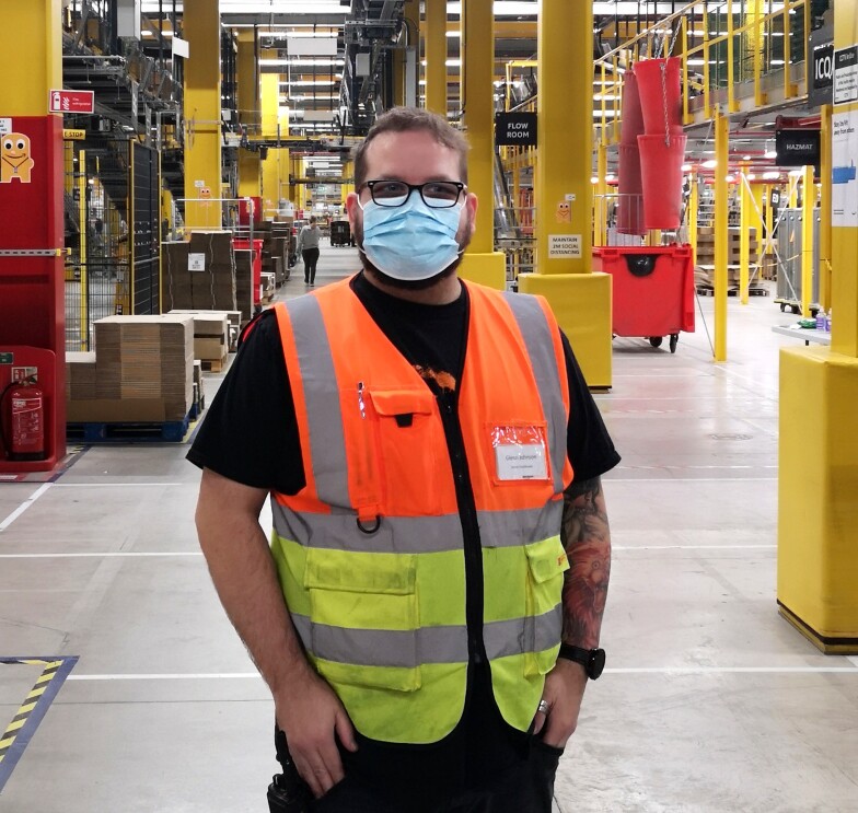 Glenn Johnson, Stores coordinator at Amazon fulfilment centre in Warrington, pictured in a high visibility vest and face mask