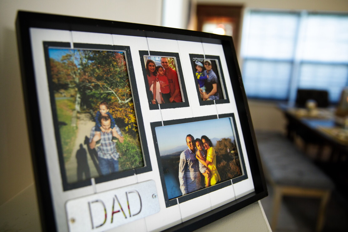 A picture frame with four separate family photos. The word "dad" is in all-capital letters in the bottom left of the frame.