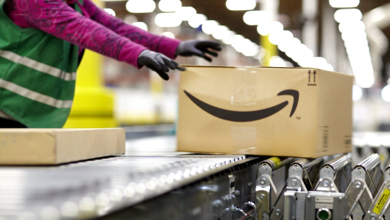Fulfillment center employee handling a large package