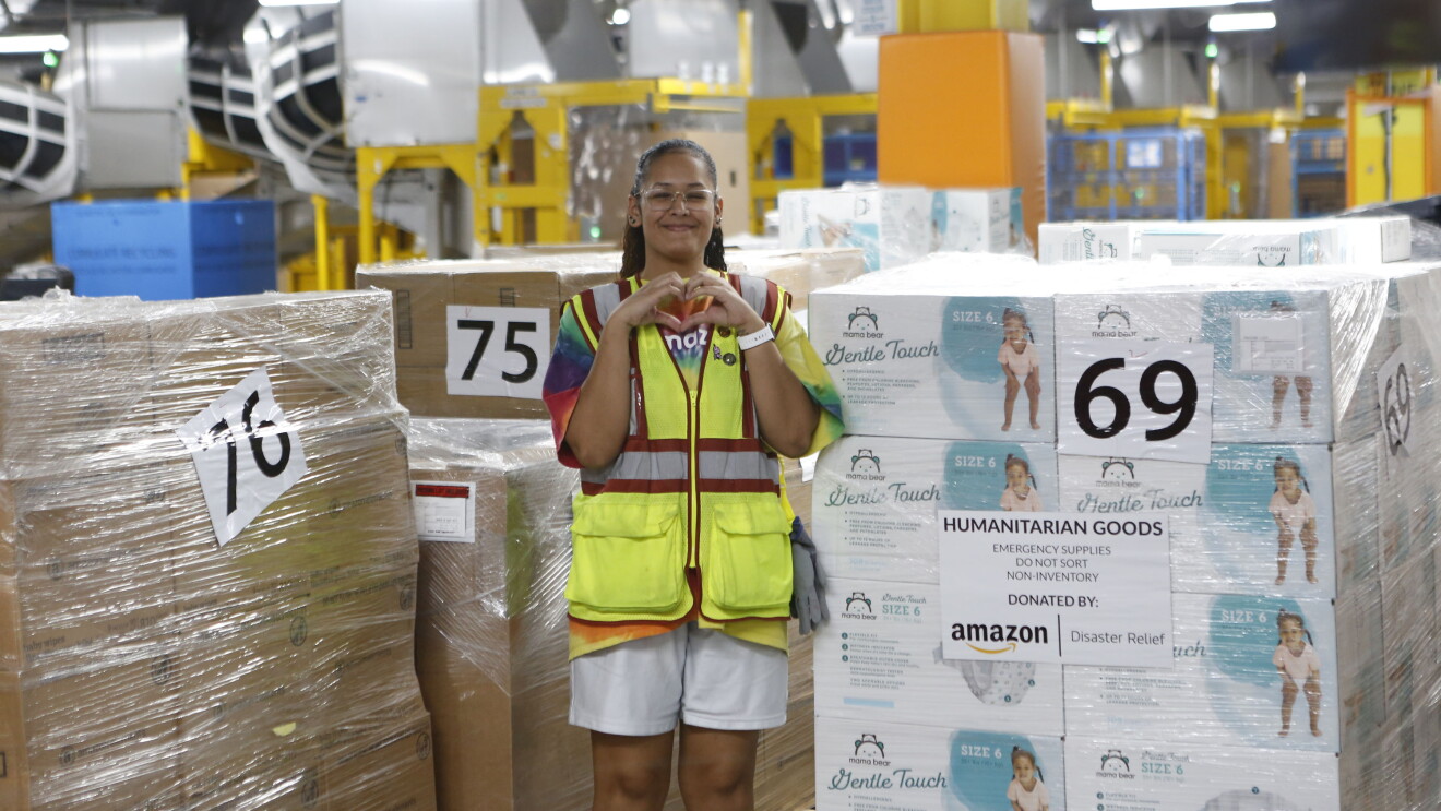 Amazon employee holding up hands in the shape of a heart