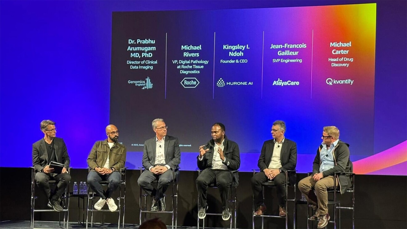A photo of expert panel of pathologists, doctors and medical technologists on stage at AWS at re:Invent 2023.