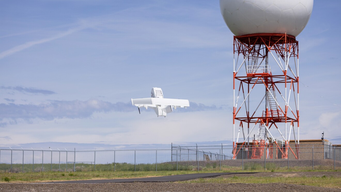 Images of an Amazon employee wearing an orange safety vest next to an Amazon drone. Images of a drone in air.