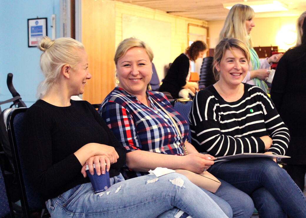 In Kind Direct charity photograph of three people sitting next to each other smiling 