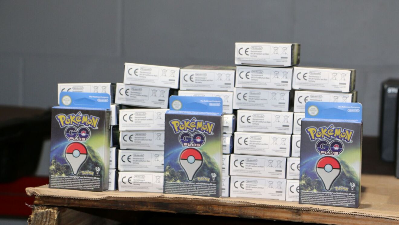 Stacks of Pokemon Go Plus boxes on wooden surface