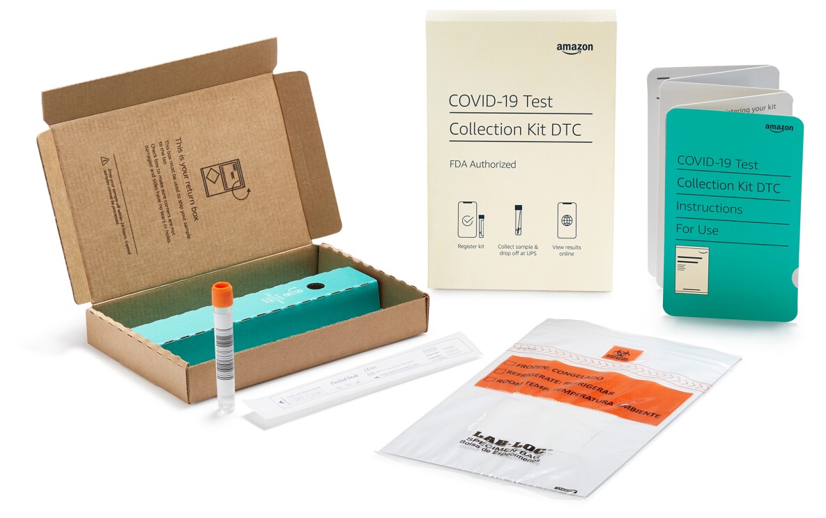 An image showing everything that is included in the at-home COVID test. There is an open box with a test tube, a plastic bag, a swab, and two pamphlets with information.