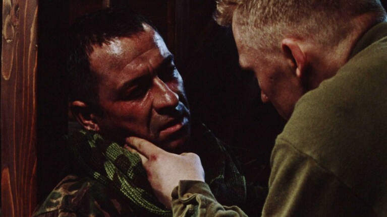 Two men in military uniforms in tense confrontation