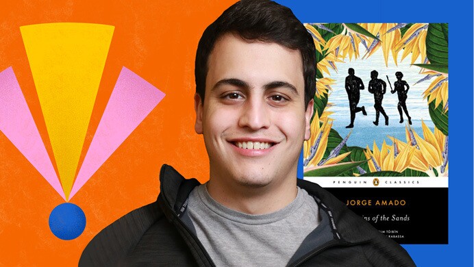 An image of Carlos Marciano, software development engineer, Amazon Ads, and a cover of a book in the background with an illustration of an exclamation mark in yellow, pink and blue. 