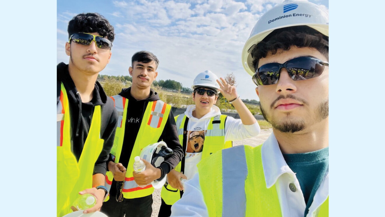A selfie of Freedom High School students Shafi Yaftali, Iqbal Noor Daudzai, Omar Noor Duadzai, and Ahmad Alizada at Amazon's solar farm.
