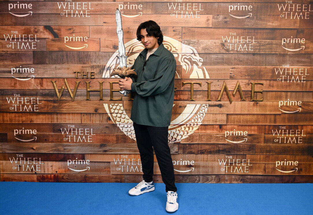 A male fan holding a sword at the wheel of time screening 