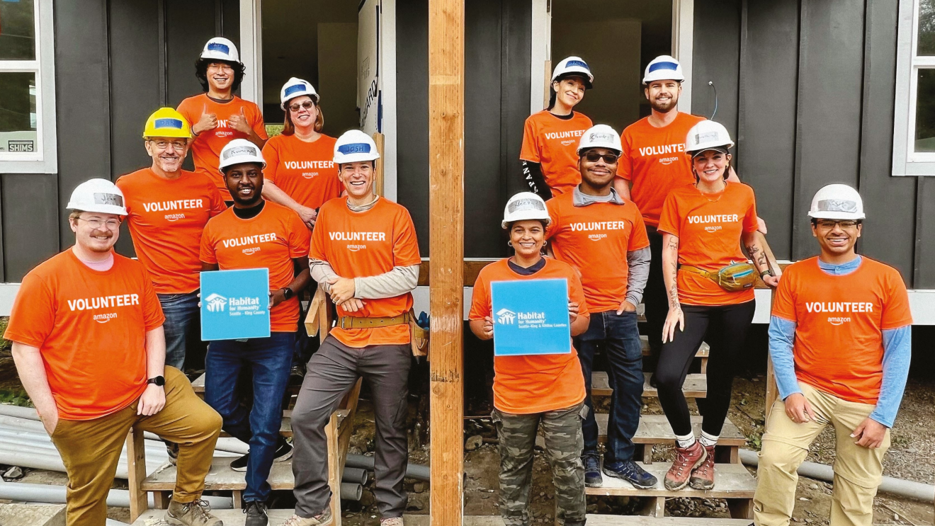Amazon volunteers with Habitat for humanity posing for a photo