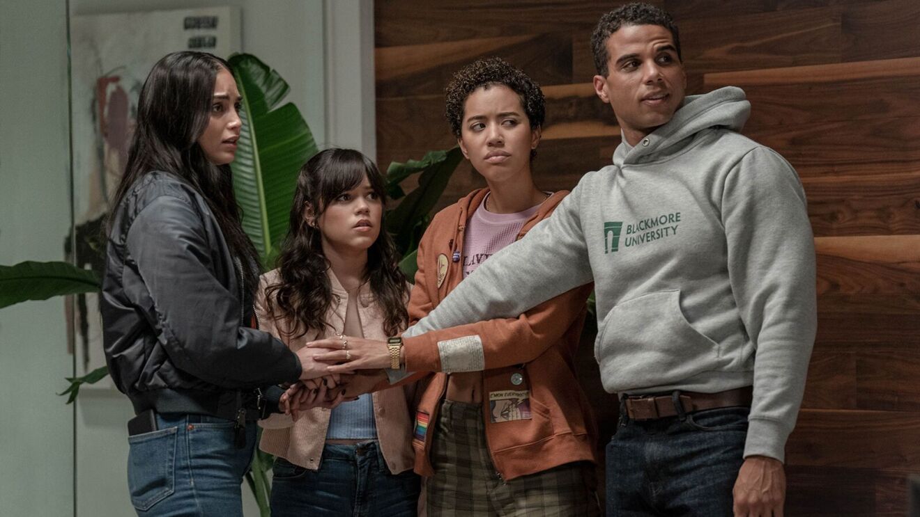 Four diverse young adults stand close together, looking concerned in Scream 6