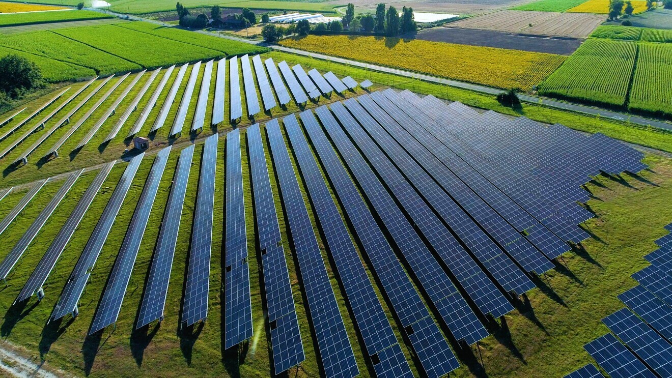 image of solar panels in a field