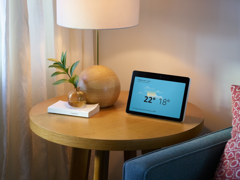 EchoShow showing weather on screen and on top of white cabinet