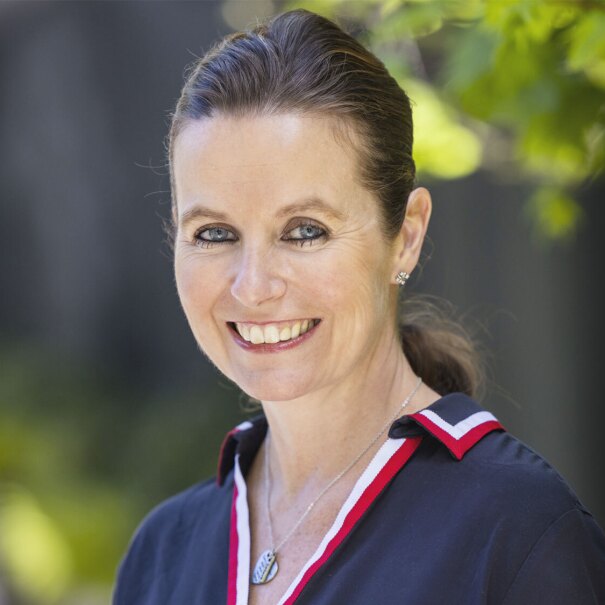 A headshot of Claire Peters standing outside.