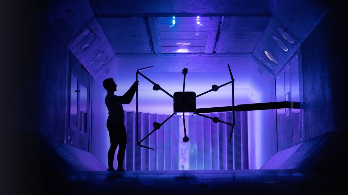 A Prime Air employee working on the MK30 delivery drone inside.