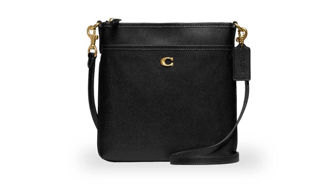 An image of a black, cross-body purse with a small, gold "C" logo for the Coach brand.