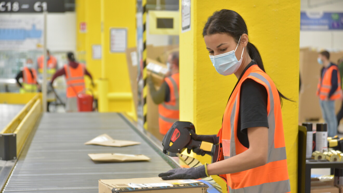 Amazon employee scanning packages
