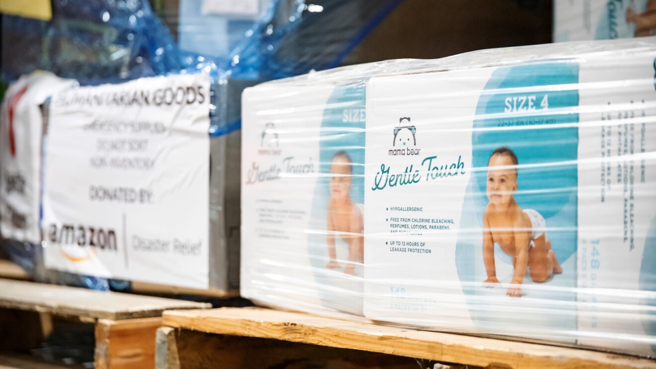 An image of a box of diapers on a shelf inside an Amazon facility