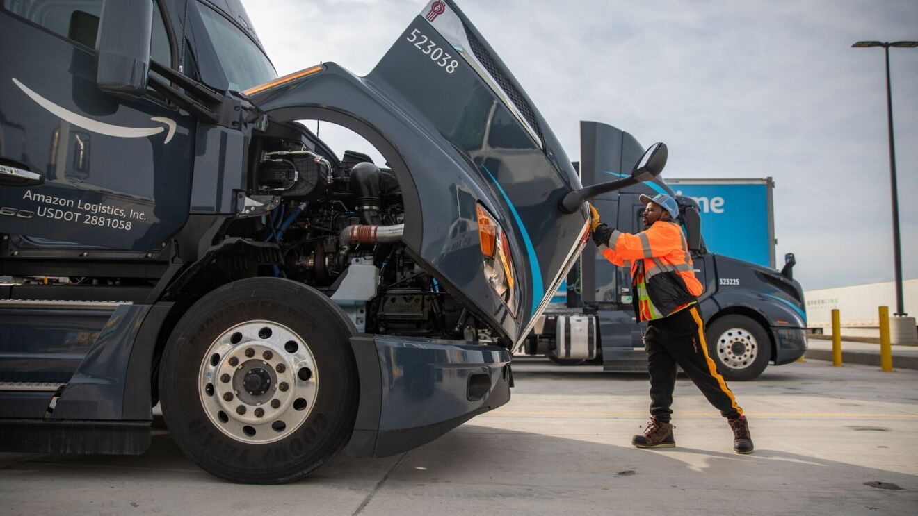 An image of Abel, an Amazon transportation team employee, and a semi-trailer truck.