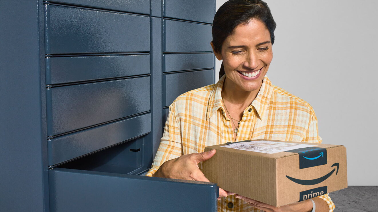 A brown-haired woman in a plaid yellow shirt picks up her Amazon package at a Locker.