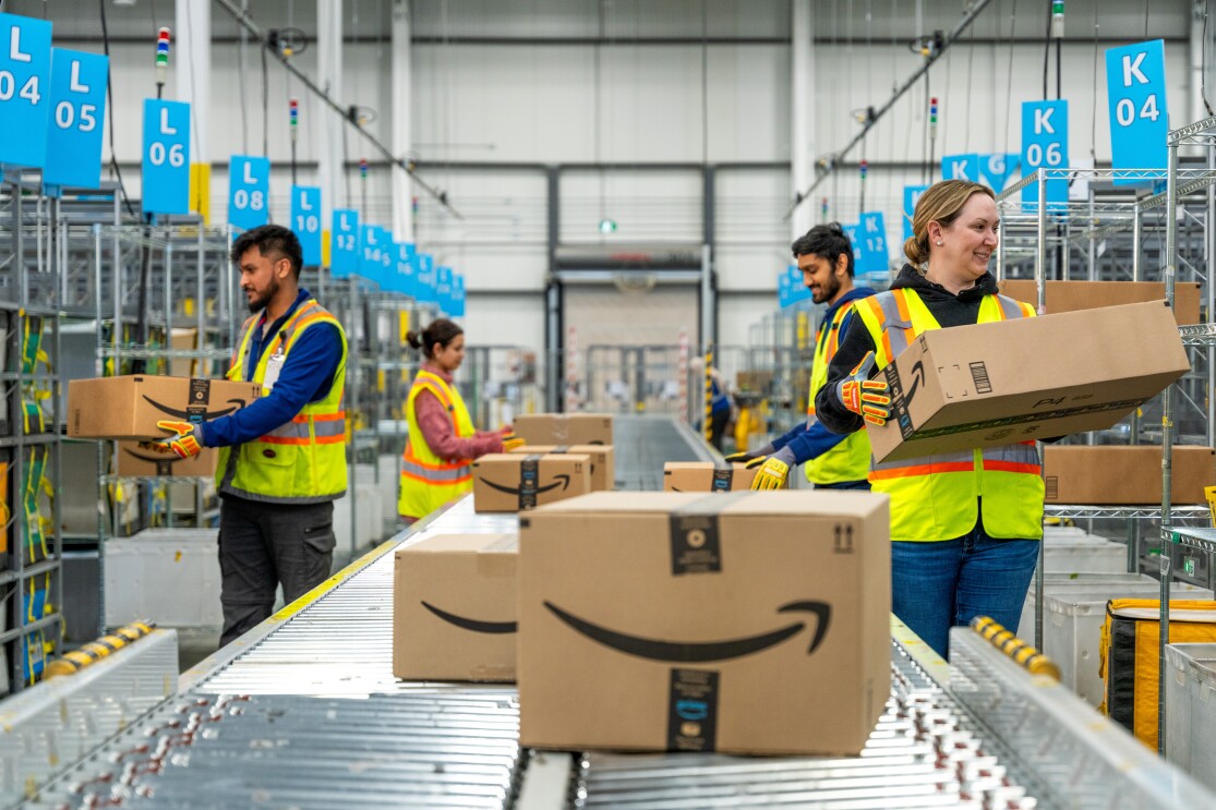 Employees moving boxes of conveyor