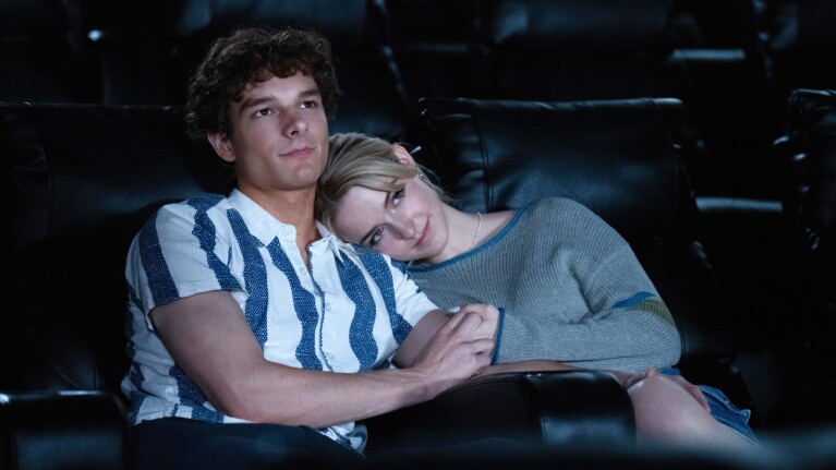 Regretting You movie still, showing young couple cuddling in dark movie theater