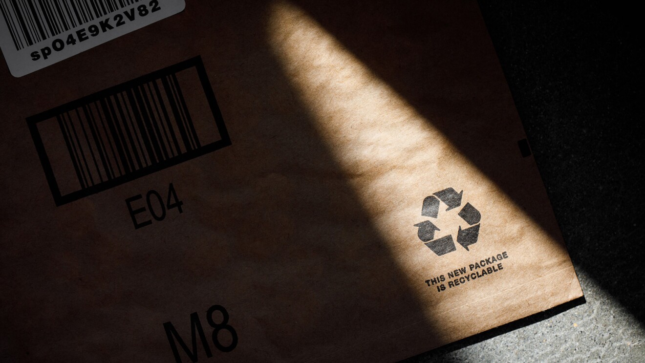 An amazon package that has a recycling symbol and reads "this new package is recyclable."